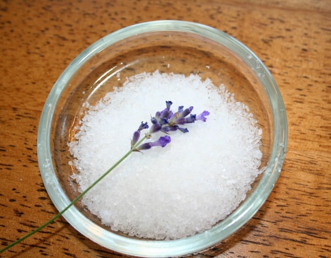 a sprig of lavender inside a dish of epsom salt