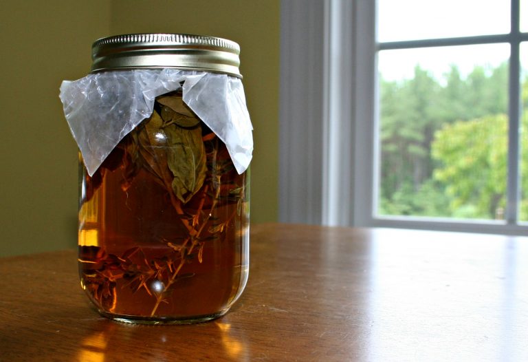 a jar of herbal vinegar on the table