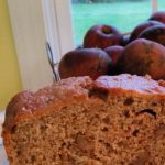 walnut applesauce bread with apples in the background