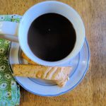 butterscotch biscotti and a cup of black coffee on a plate