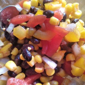 a close up of corn, tomato and black bean salad