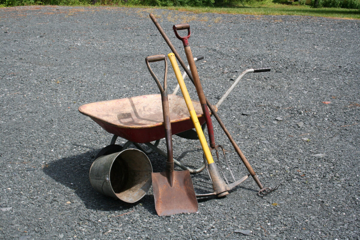 wheelbarrow, shovel, pick ax, rake