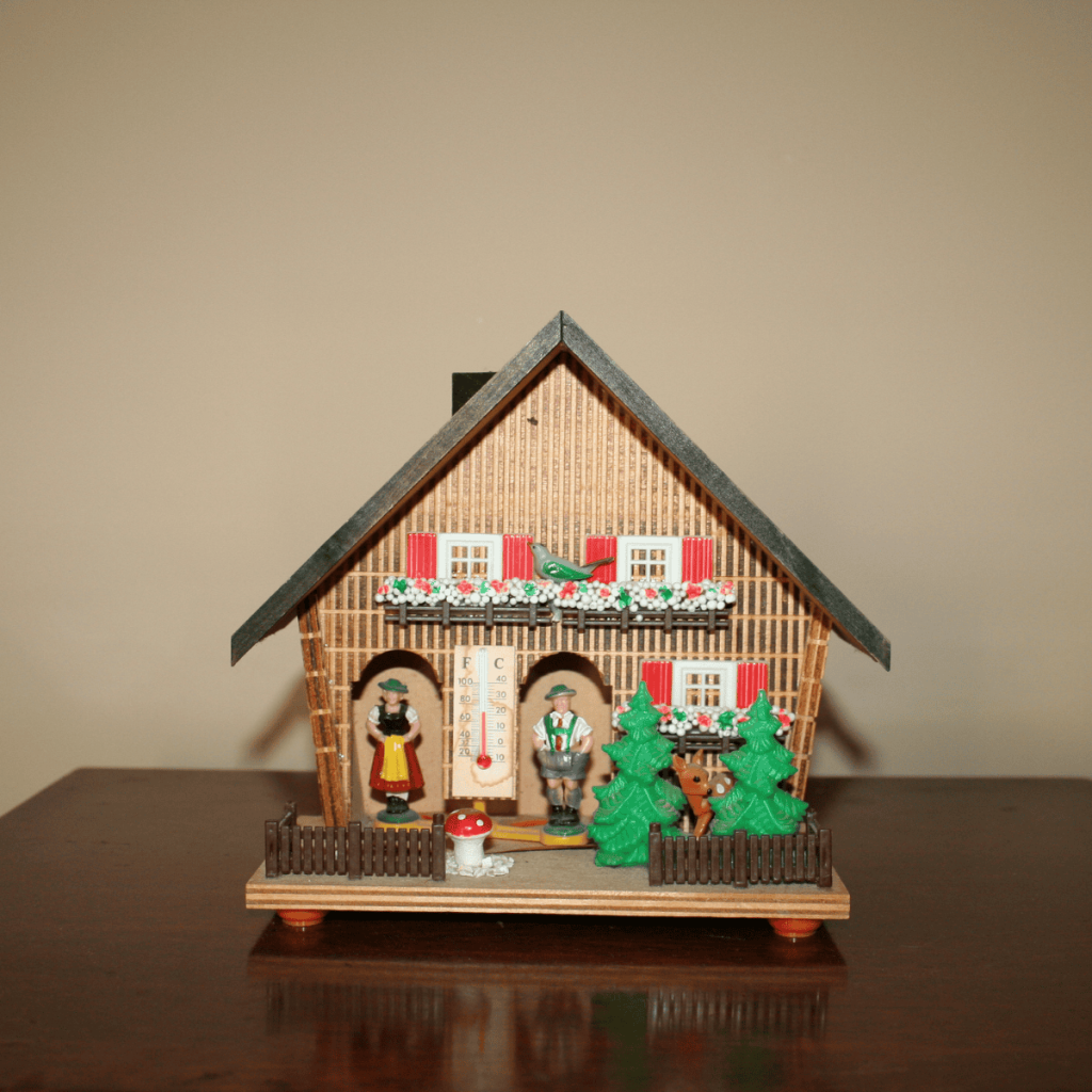 a vintage folk art weather house which accurately predicts the weather