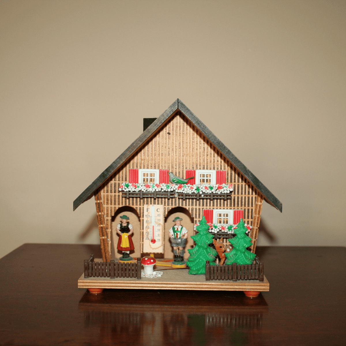 a vintage folk art weather house which accurately predicts the weather